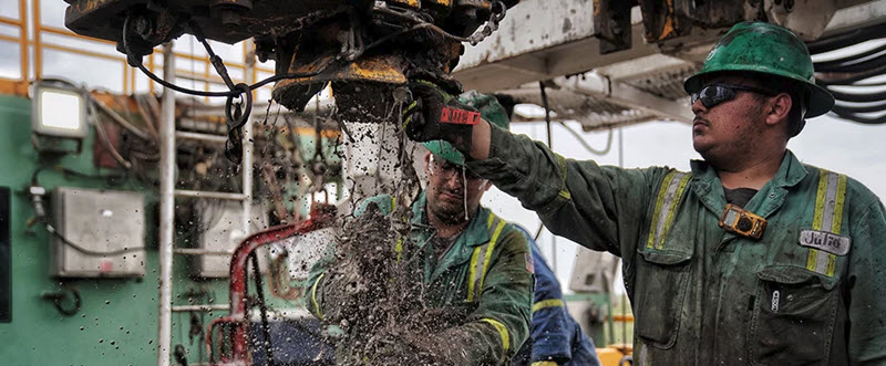 rough neck working in oil field